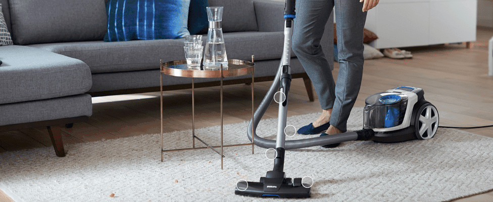Zooms in on multiple points along the hose and floor nozzle to show the tool's flexible, reachable design.