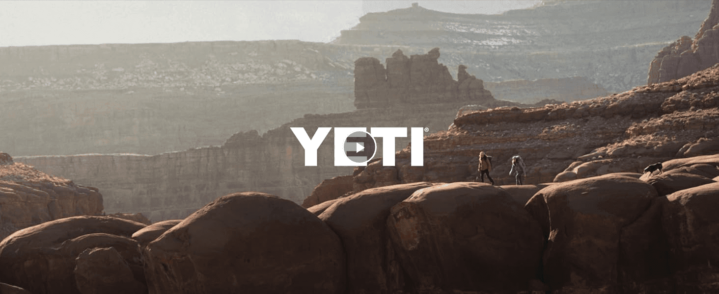 Uses an outdoor adventure video scene with the YETI logo to evoke the brand's rugged, outdoors lifestyle identity.
