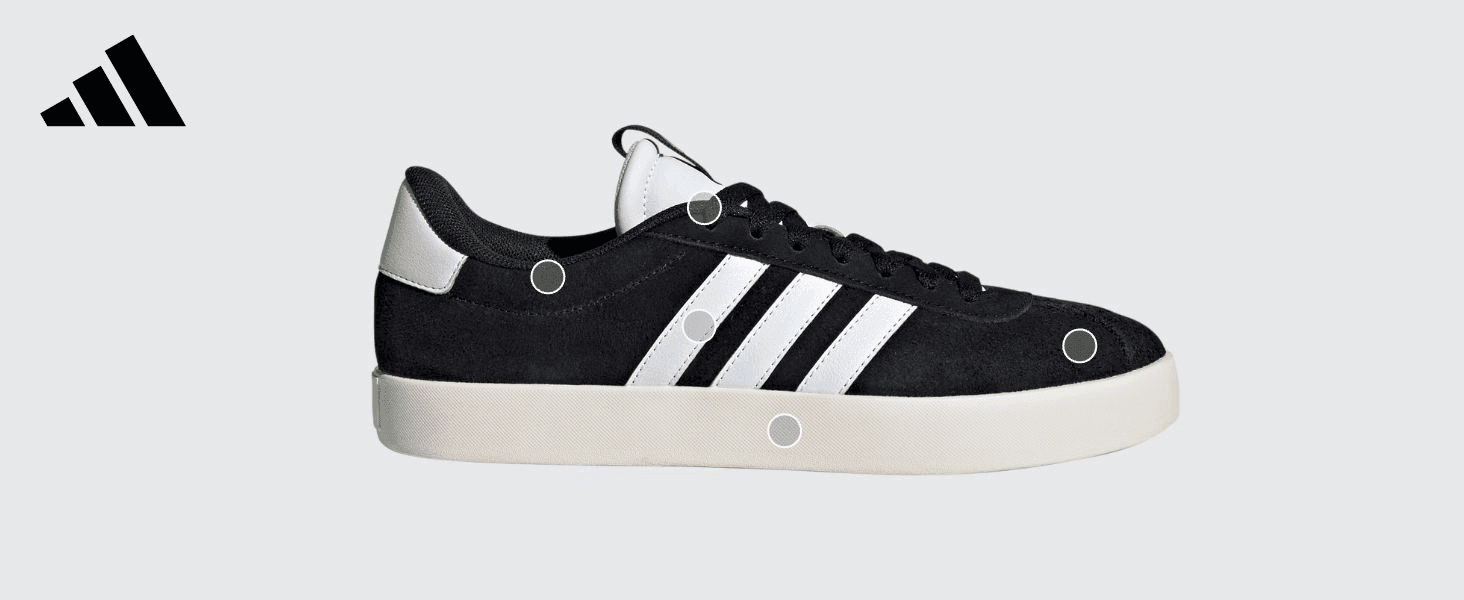 Points to key physical zones of the shoe (heel, stripes, sole) to highlight its build and materials.