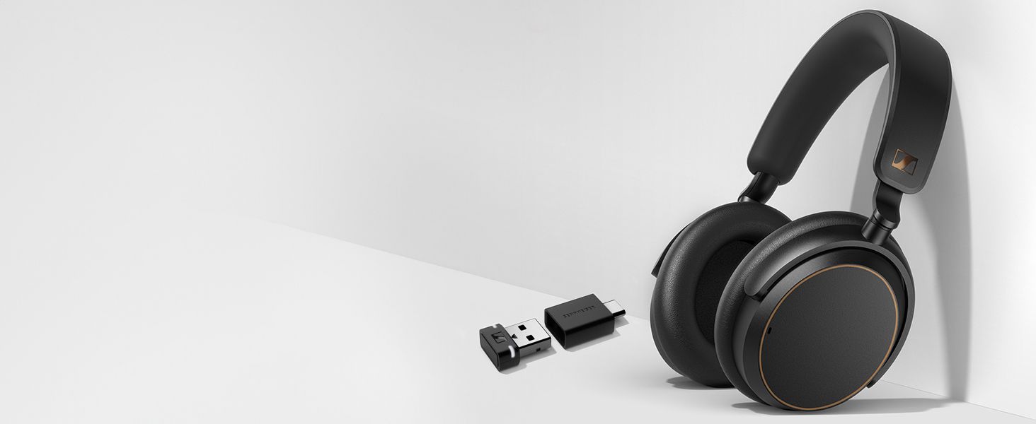 Shows the headphones beside the included BTD 600 dongle so shoppers know what arrives in the box.