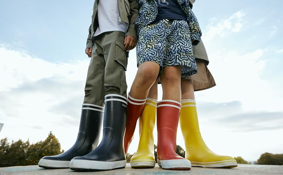 Shows the product (rain boots) in a real-world outdoor setting to help shoppers envision ownership and usage scenarios.