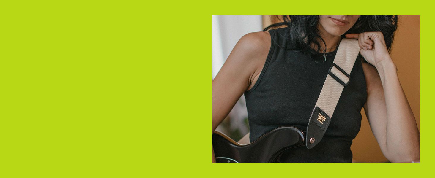 Shows a guitarist wearing the strap during play to help shoppers envision owning it.