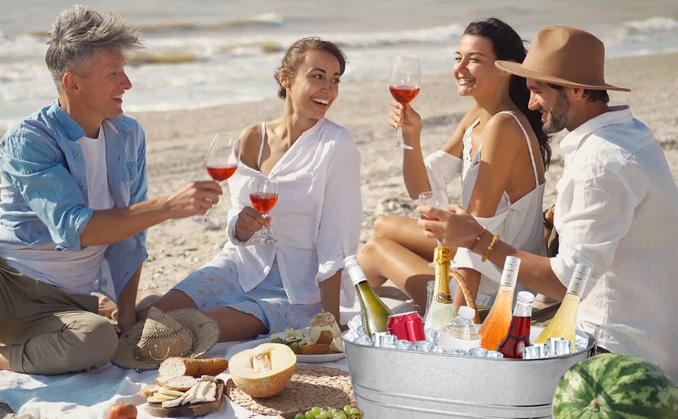Shows friends enjoying wine and drinks at a sunny beach picnic to help shoppers envision the product in a relaxed social setting.