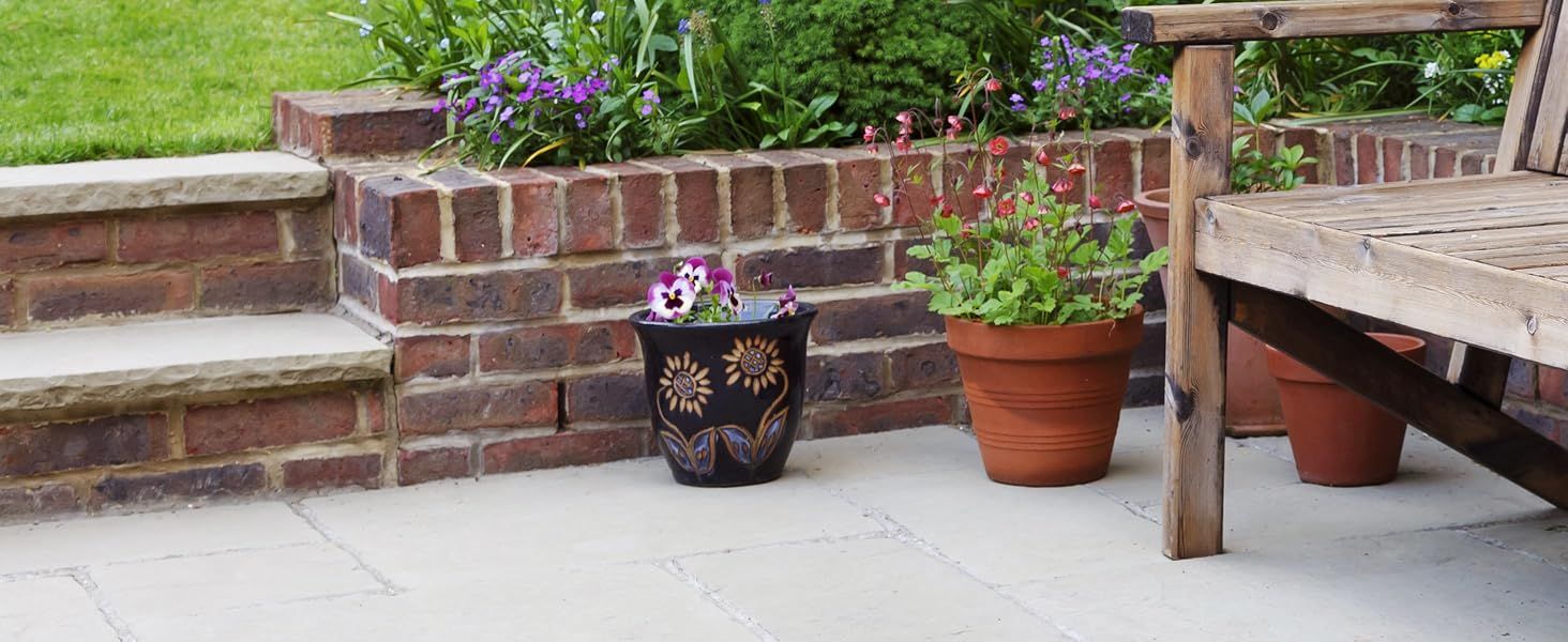 Shows a relaxed garden patio with potted plants and furniture to help shoppers picture the product in an outdoor setting.
