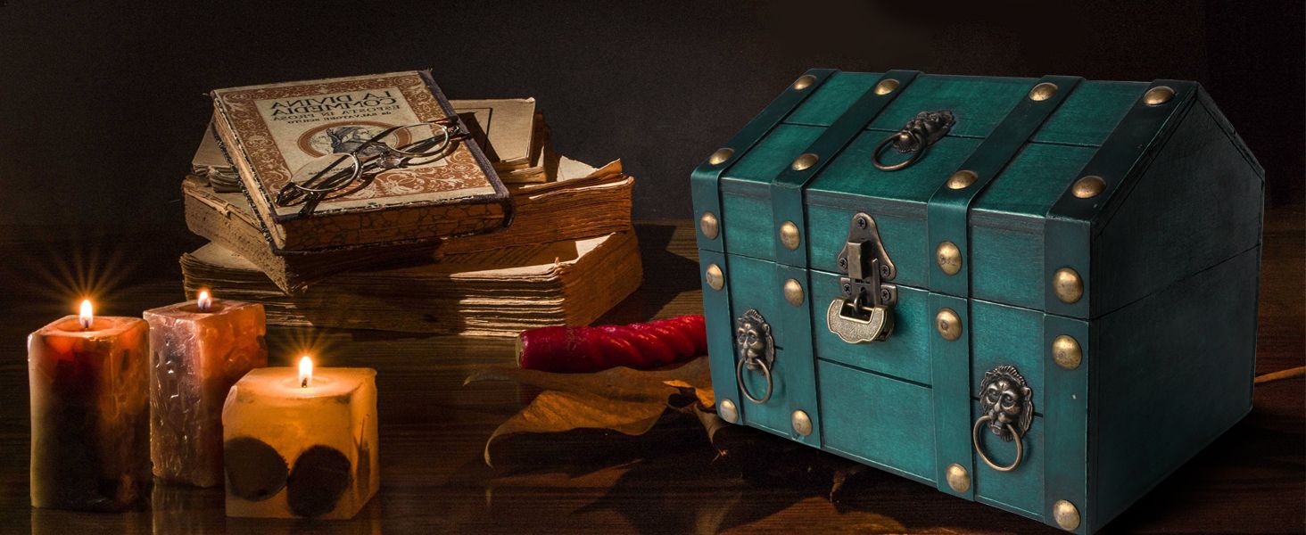 Places the teal treasure chest in a moody vintage setting with candles and old books so shoppers can picture it as a decorative keepsake piece.