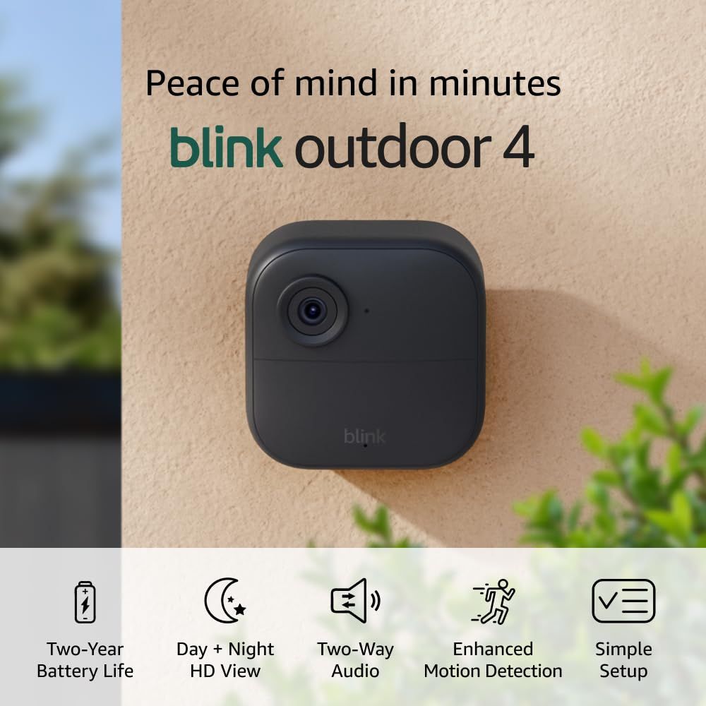 Shows the Blink Outdoor 4 camera mounted on an exterior wall in a real home setting to demonstrate its outdoor use case and help shoppers visualize how it…