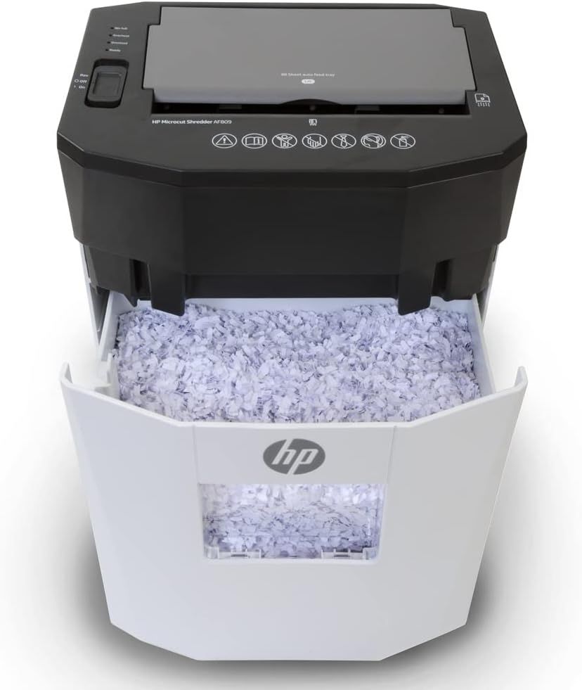 Shows the HP paper shredder in action with its collection bin full of shredded paper, demonstrating the product's core function and reassuring shoppers that it effectively destroys documents for…