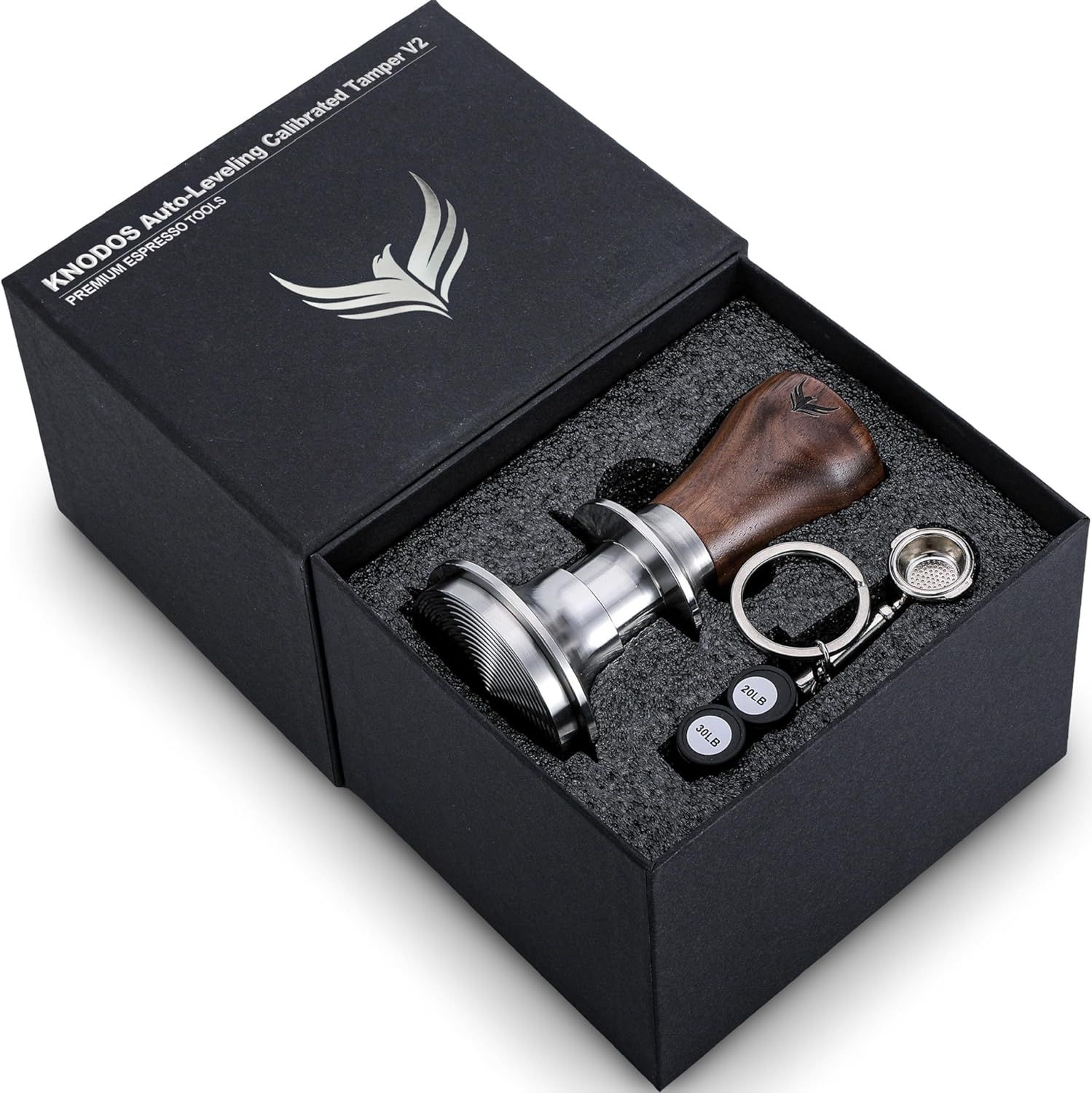 Displays the core product—an espresso tamper with wooden handle and metal base—along with included accessories in premium packaging to communicate quality and completeness of the set. Shows that the…