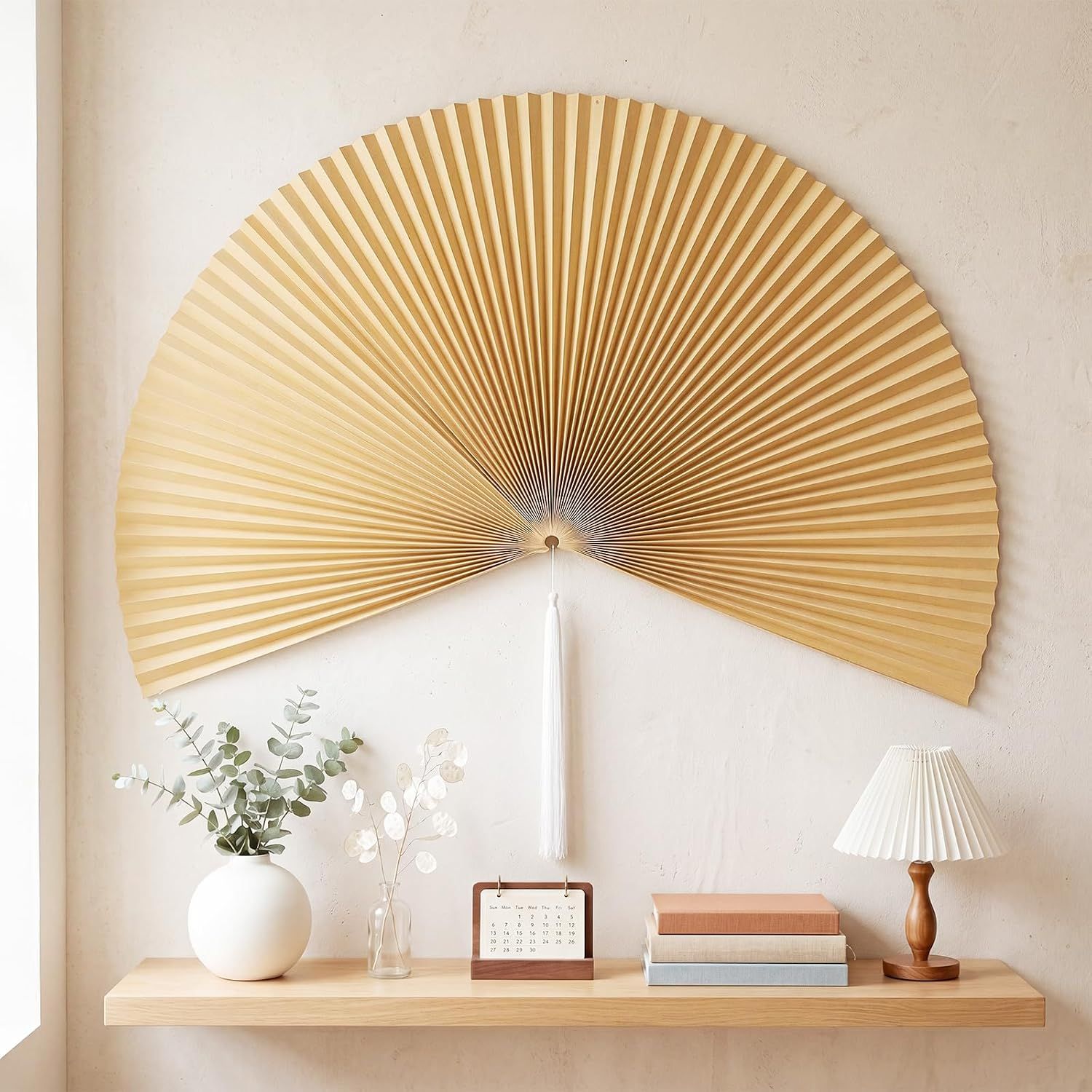 Shows the decorative fan in a styled home environment to help shoppers visualize how the product looks when displayed on a wall with complementary decor items. Displays the core product, a large…