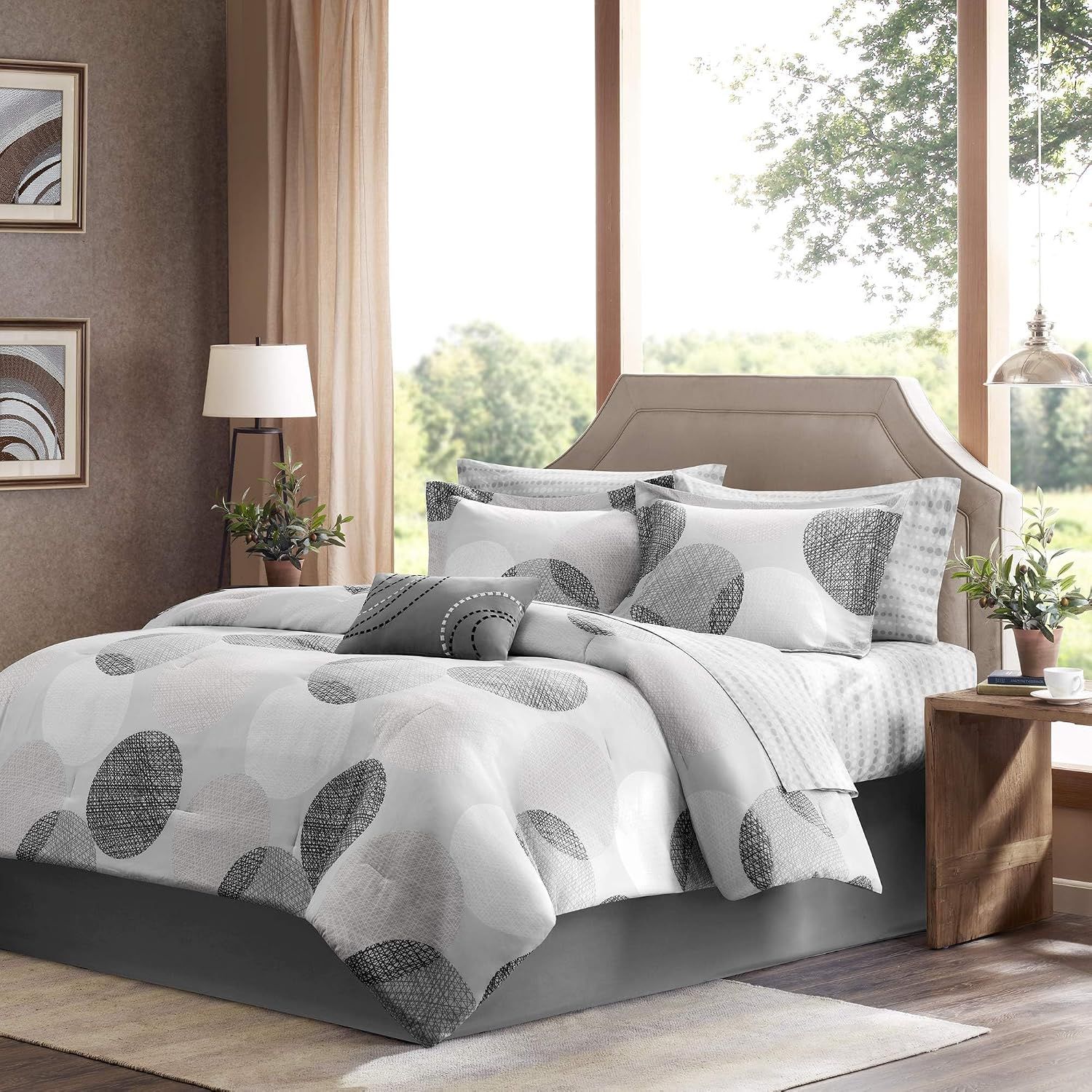 Displays the complete bedding set including comforter, shams, and decorative pillows to show shoppers the full product offering and coordinated design. Shows the bedding set in a fully styled…