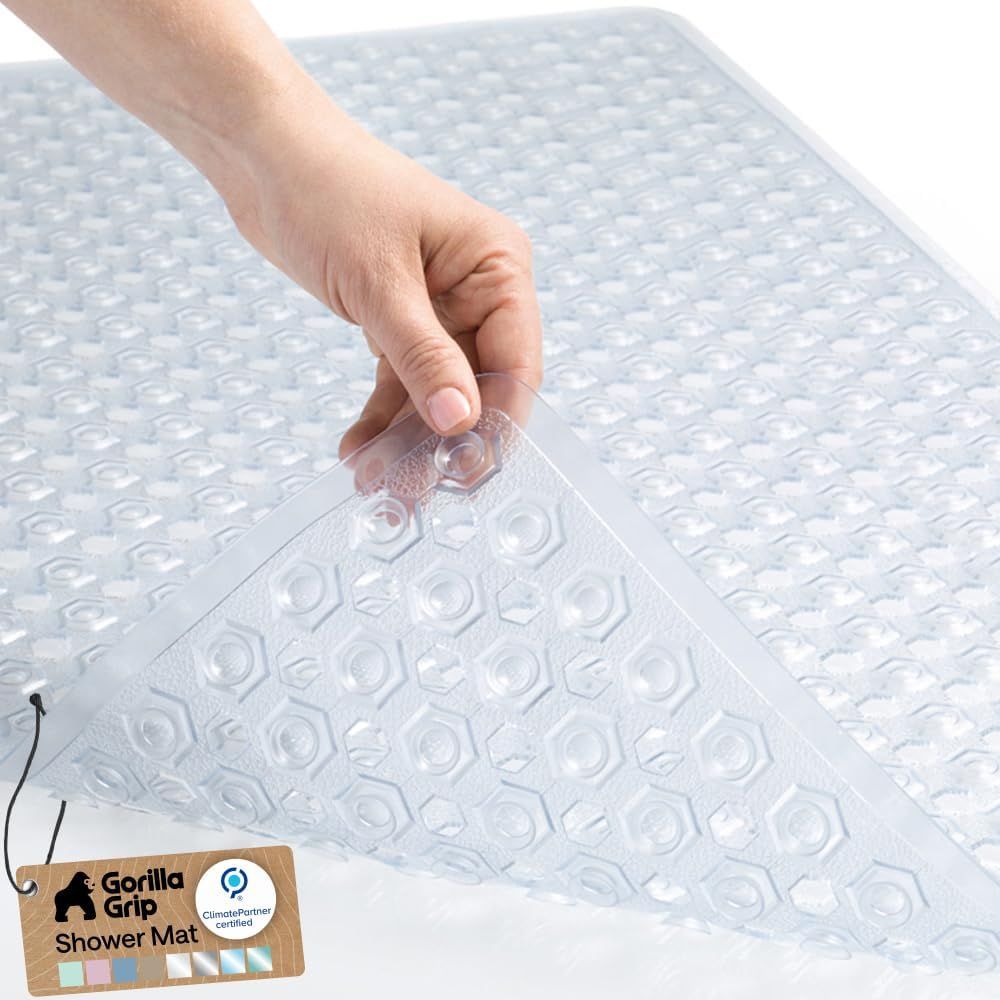 Shows a human hand interacting with the shower mat to demonstrate its size, texture, and ease of handling, helping shoppers understand the product's real-world scale and tactile quality.…