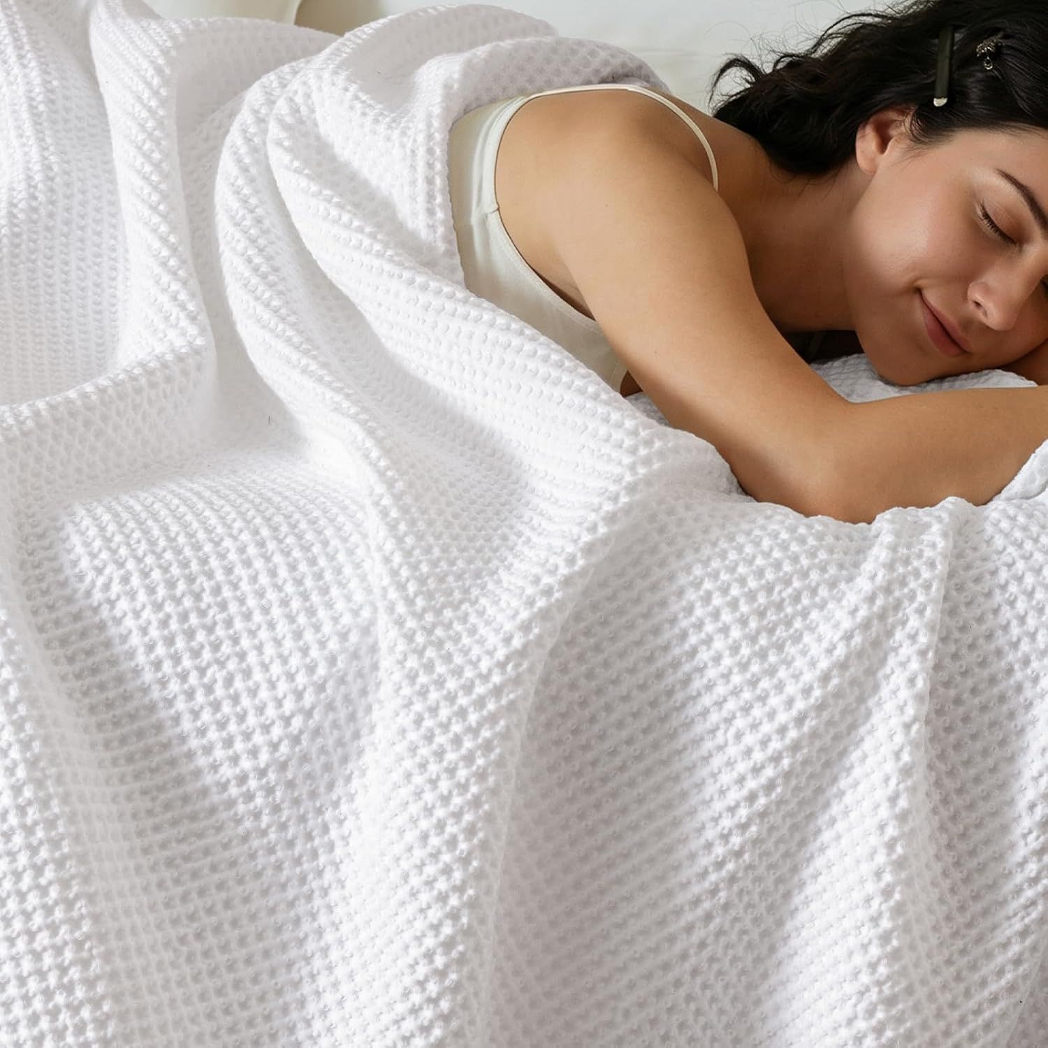 Displays the core product, a white textured blanket, prominently in the image to show its appearance and texture. Shows a person using the blanket to demonstrate its comfort, softness, and…