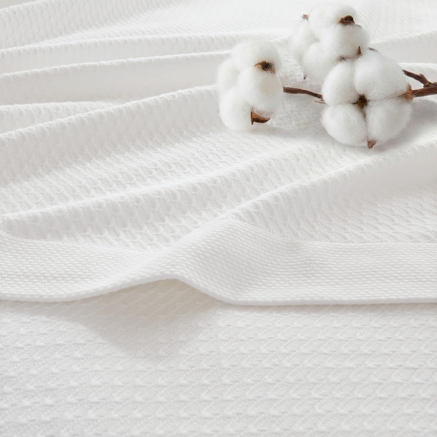 Showcases the product's soft, natural cotton fabric with a lifestyle prop (cotton plant) to emphasize the premium, natural material quality and softness of the textile. Presents the product in a…