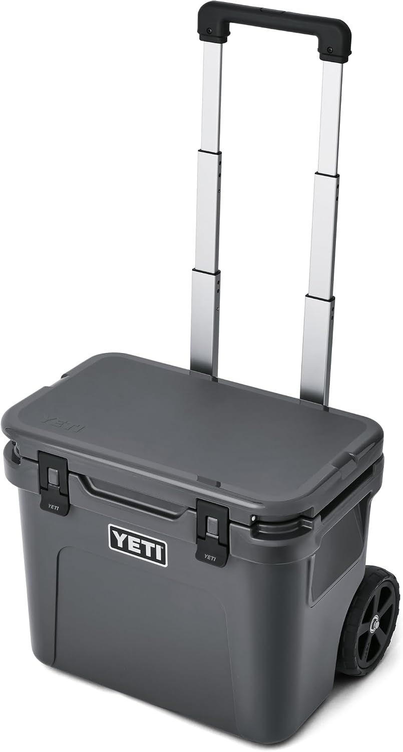 Displays the core product clearly on a white background to show the cooler's design, wheels, and telescoping handle feature for easy transport. Demonstrates the cooler's key functional features—the…