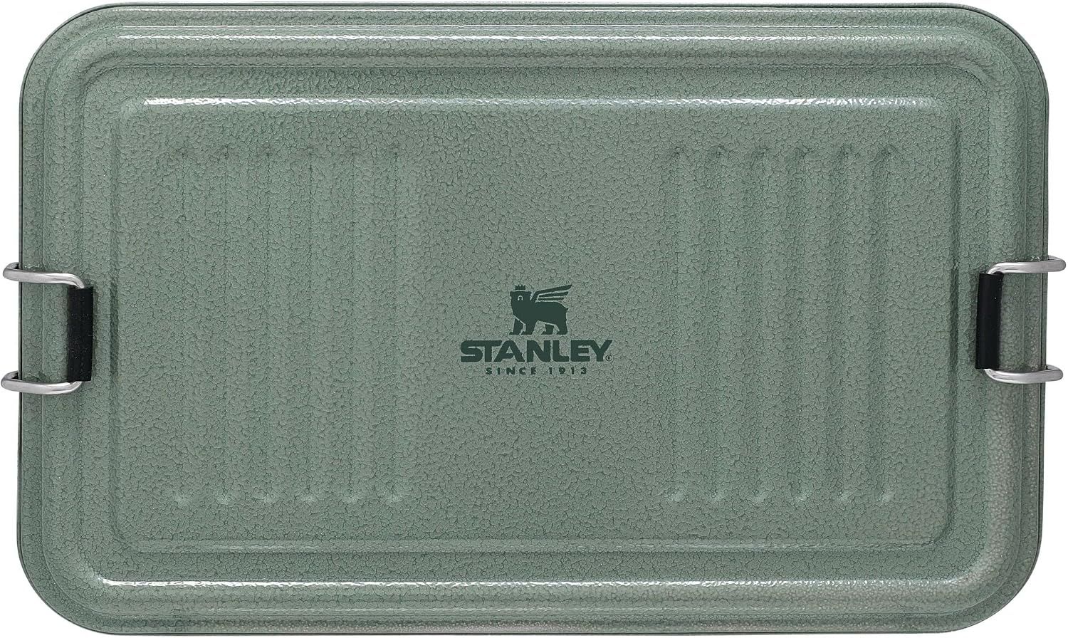 Displays the Stanley cooler lid prominently to showcase the brand, durable construction, and secure latch system that keeps contents cold and protected.