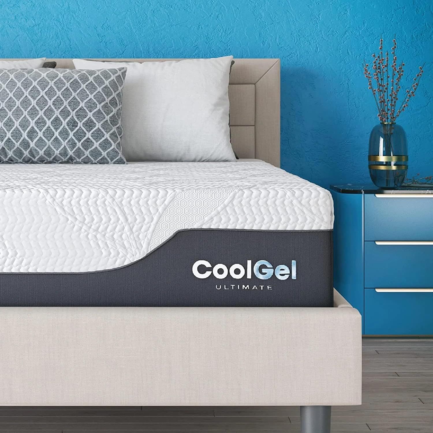 Shows the mattress in a real bedroom environment to help shoppers visualize how the product will look and fit in their own home. Displays the CoolGel Ultimate branding on the mattress side panel to…
