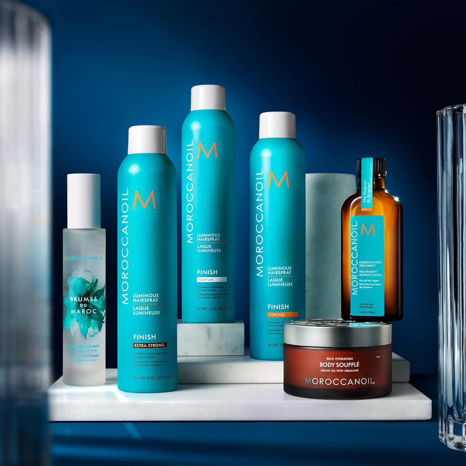 Shows the full range of products included in the Moroccanoil line, highlighting the different hair sprays, treatments, and body care items available.