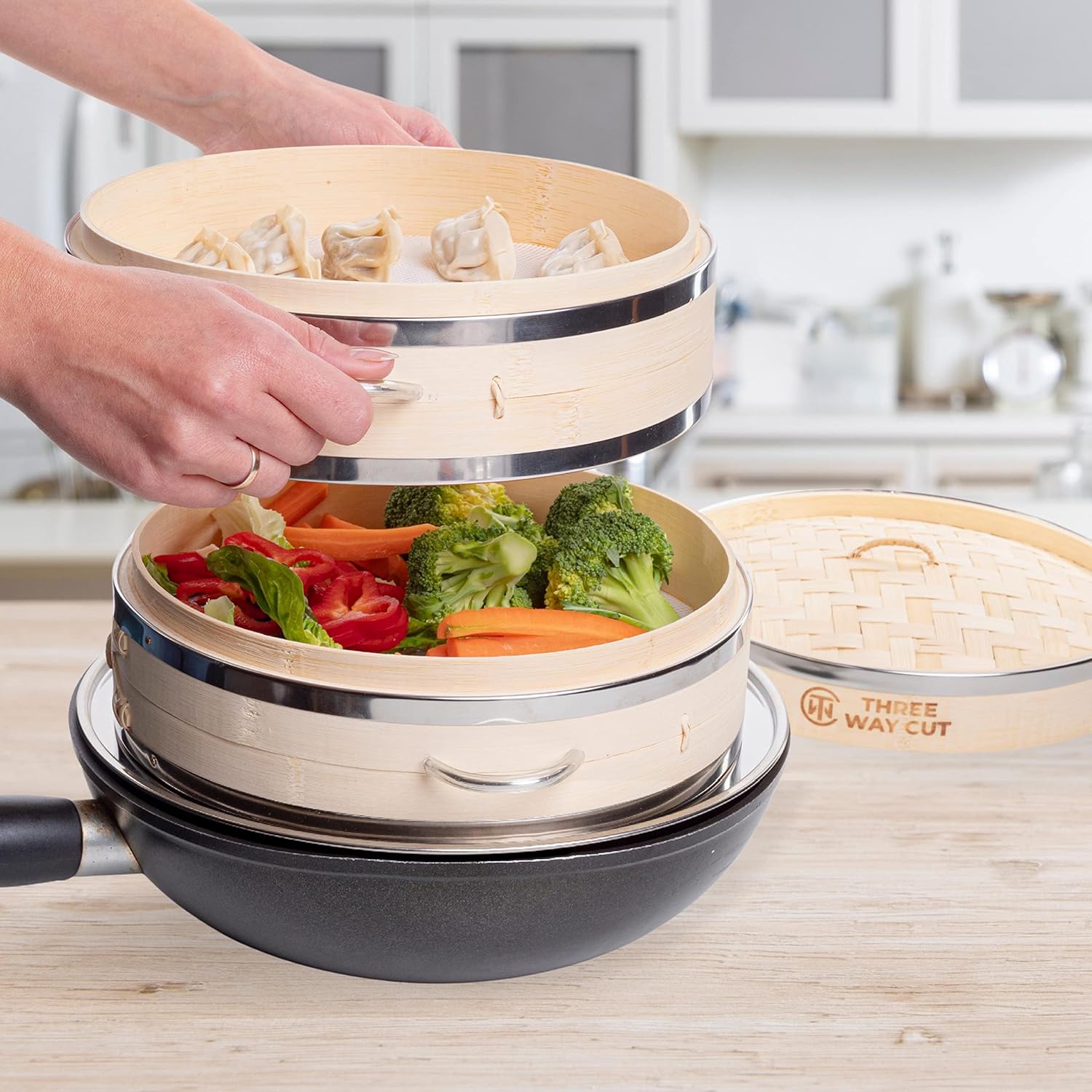 Demonstrates how to use the product for steaming multiple types of food simultaneously, showcasing its versatility and efficiency in cooking.
