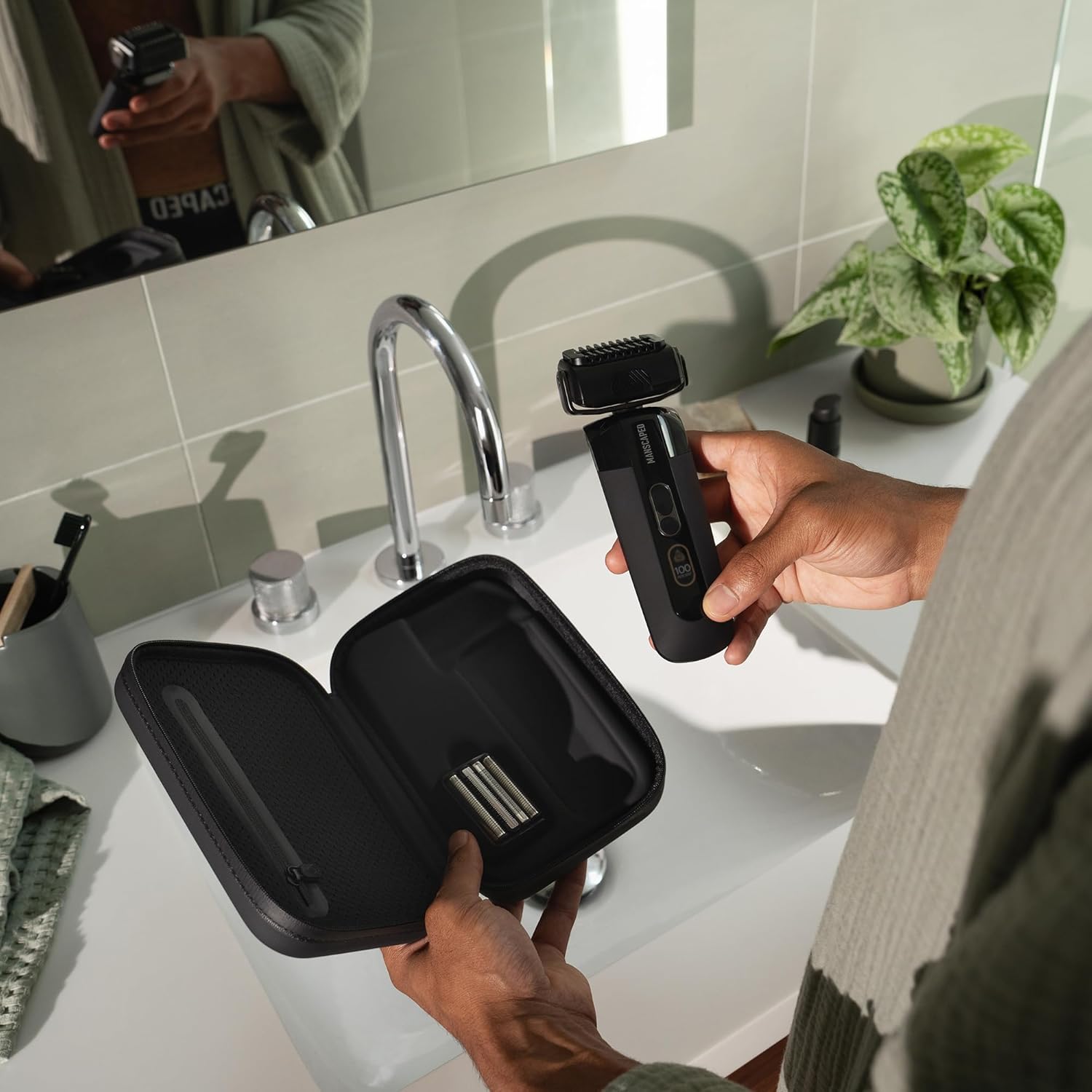 user stood over sink with product