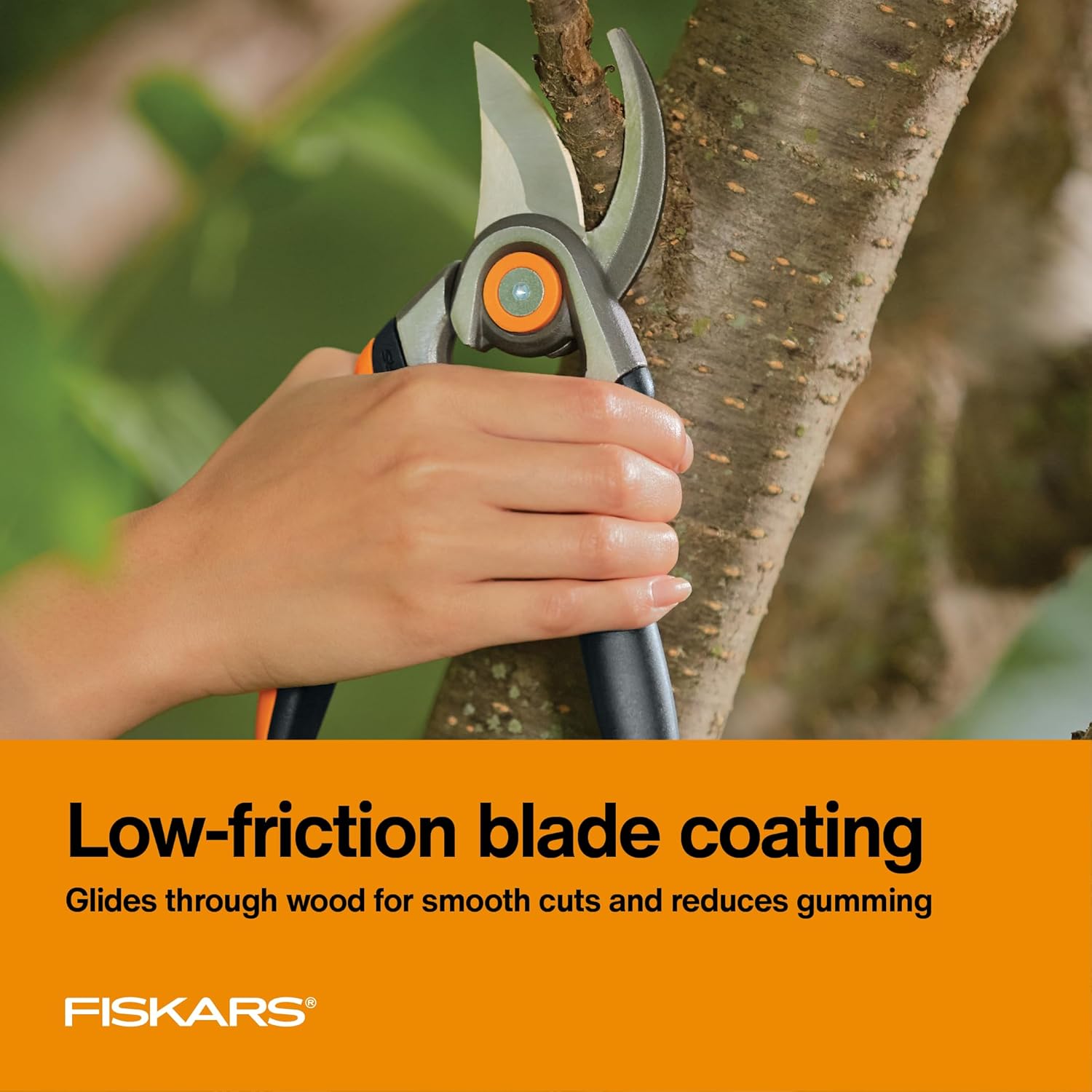 Highlights the pruning shears' low-friction blade coating that enables smooth cuts and reduces gumming when cutting wood.