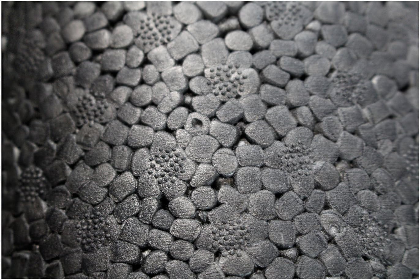 Highlights the unique textured surface of the product, showcasing its intricate pattern and potentially non-slip or grip-enhancing properties.