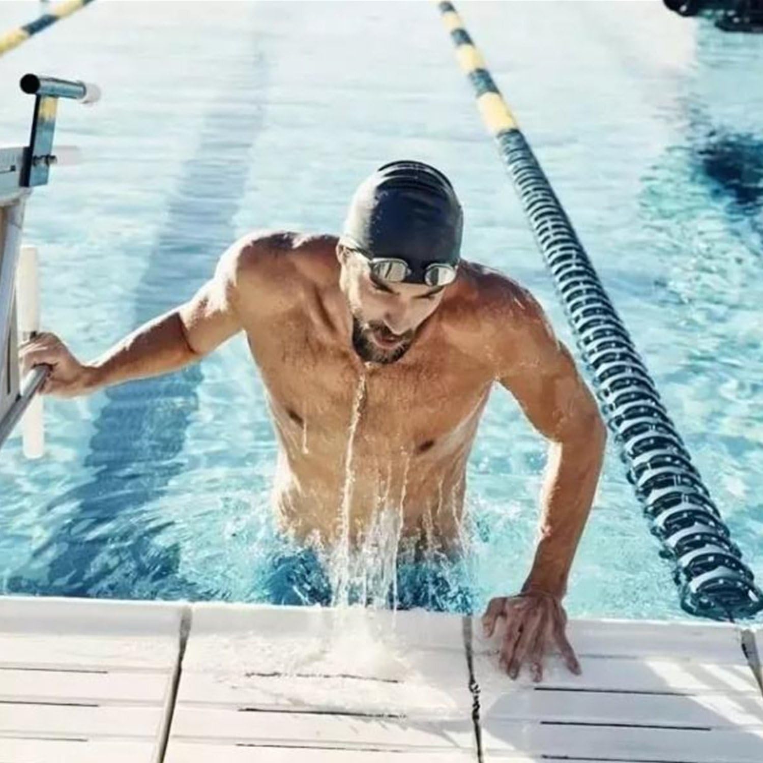 Shows the product (swimming goggles) in use during intense athletic activity, demonstrating its effectiveness in a competitive swimming environment.