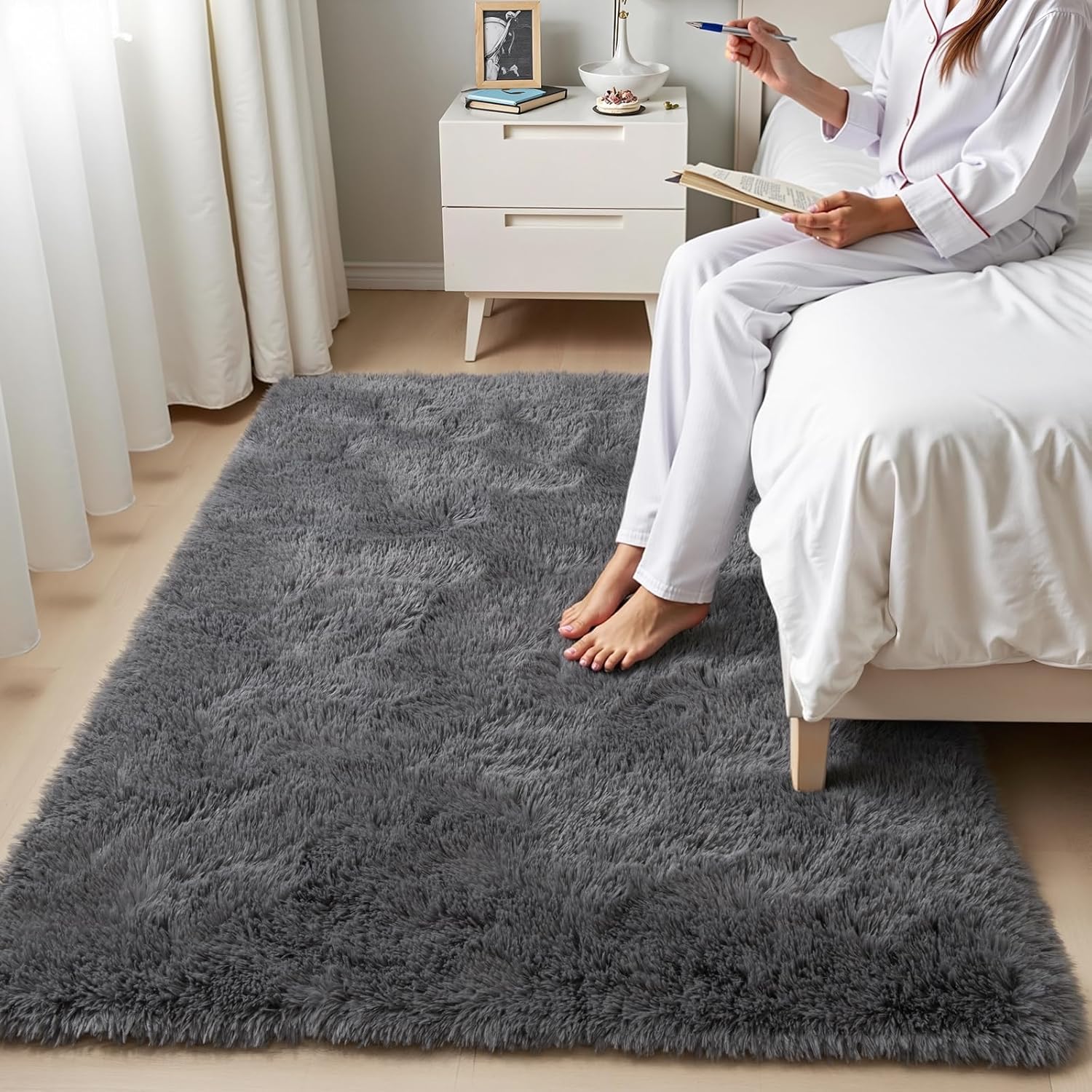 Showcases the plush, comfortable texture of the rug in a real bedroom setting to emphasize its cozy feel and aesthetic appeal. Highlights the rug's soft, plush texture by showing a person's bare…