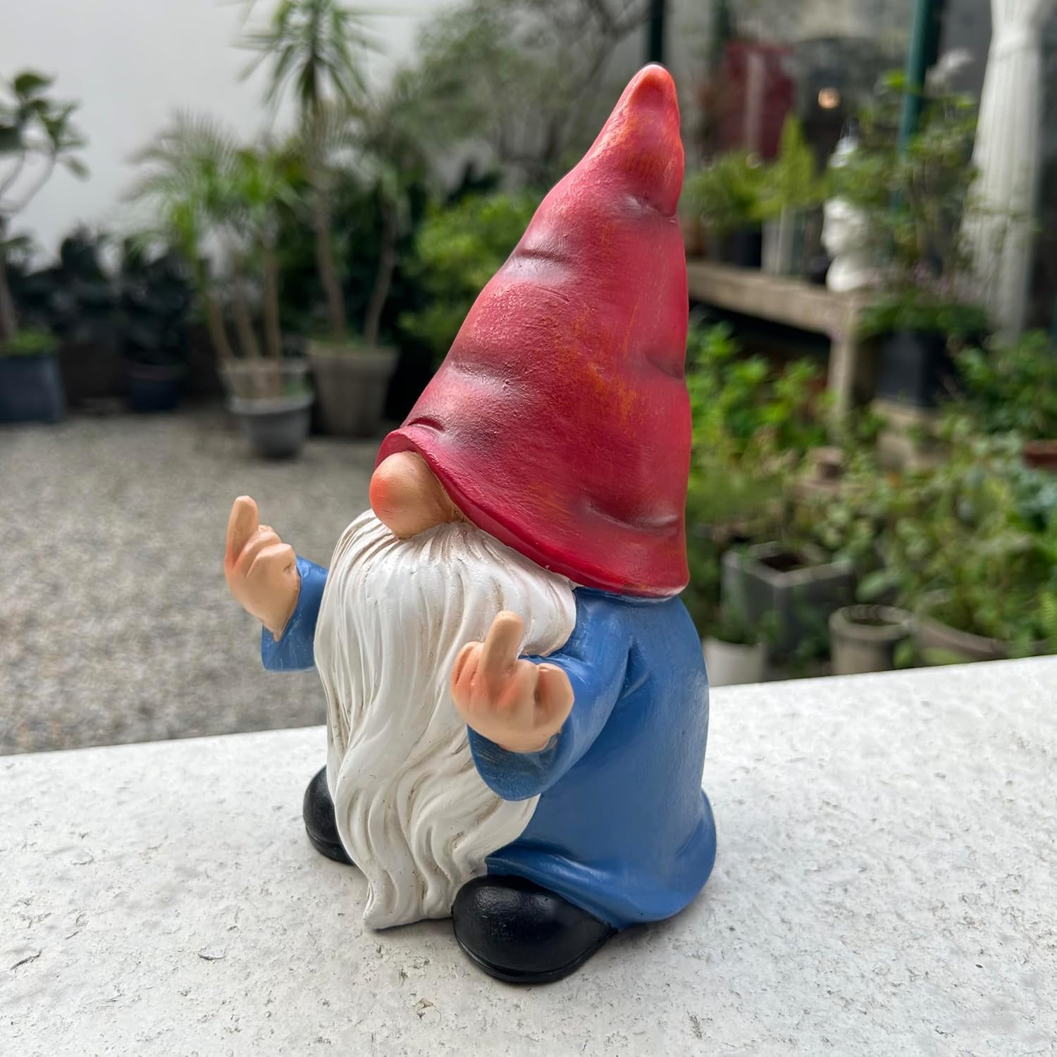 Shows the product in a real-world garden setting to demonstrate how it can be used as outdoor decor.