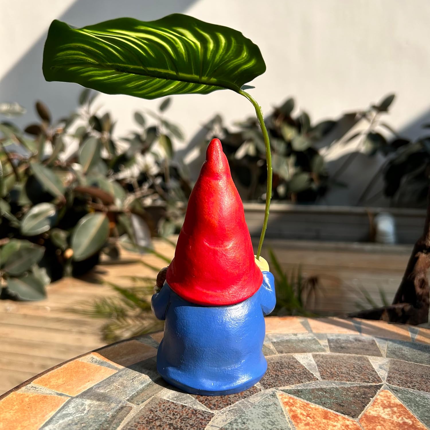 Shows the product in a real-world garden setting to demonstrate how it can be used as outdoor decoration.