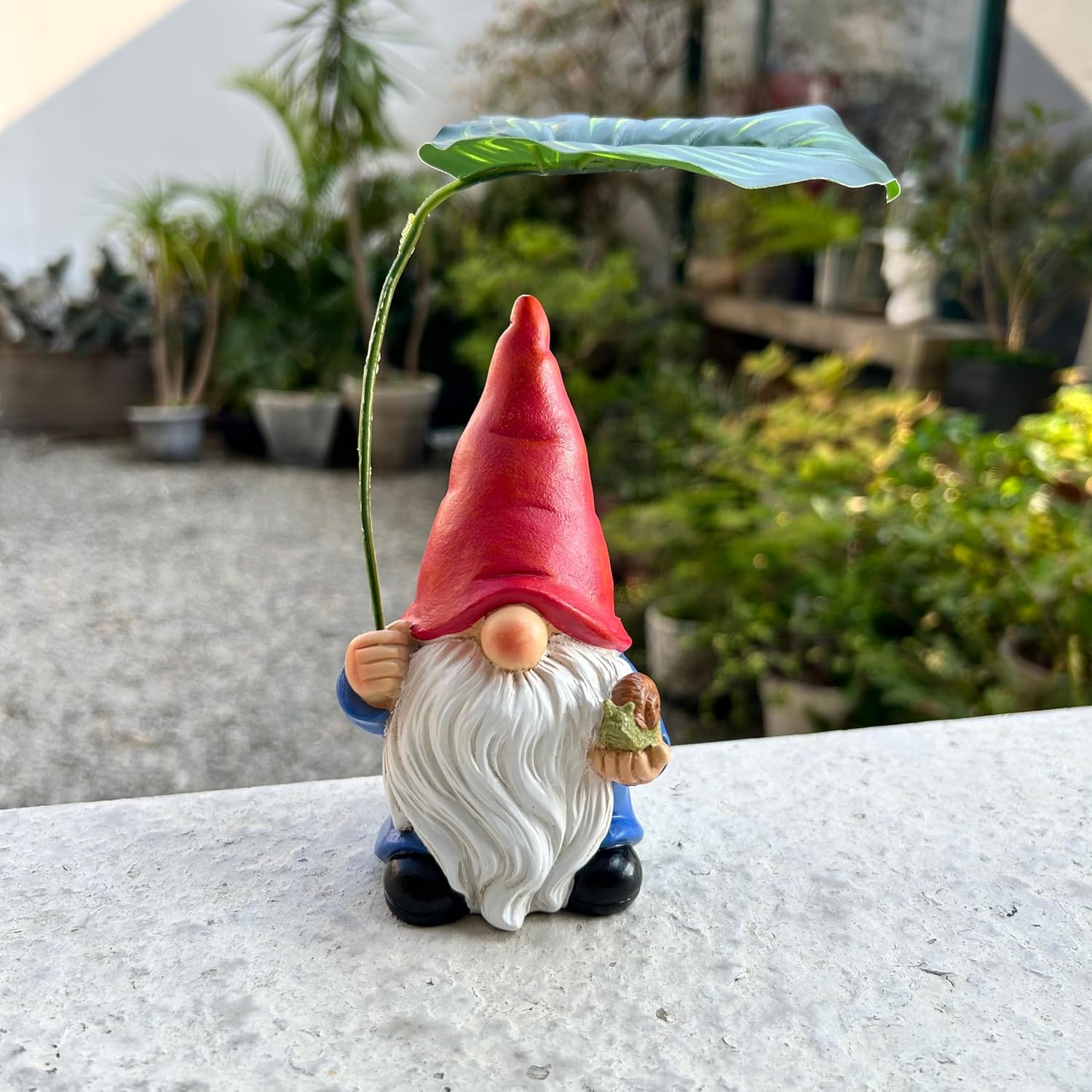 Shows the product in a real-world garden setting to demonstrate its use as outdoor decor.