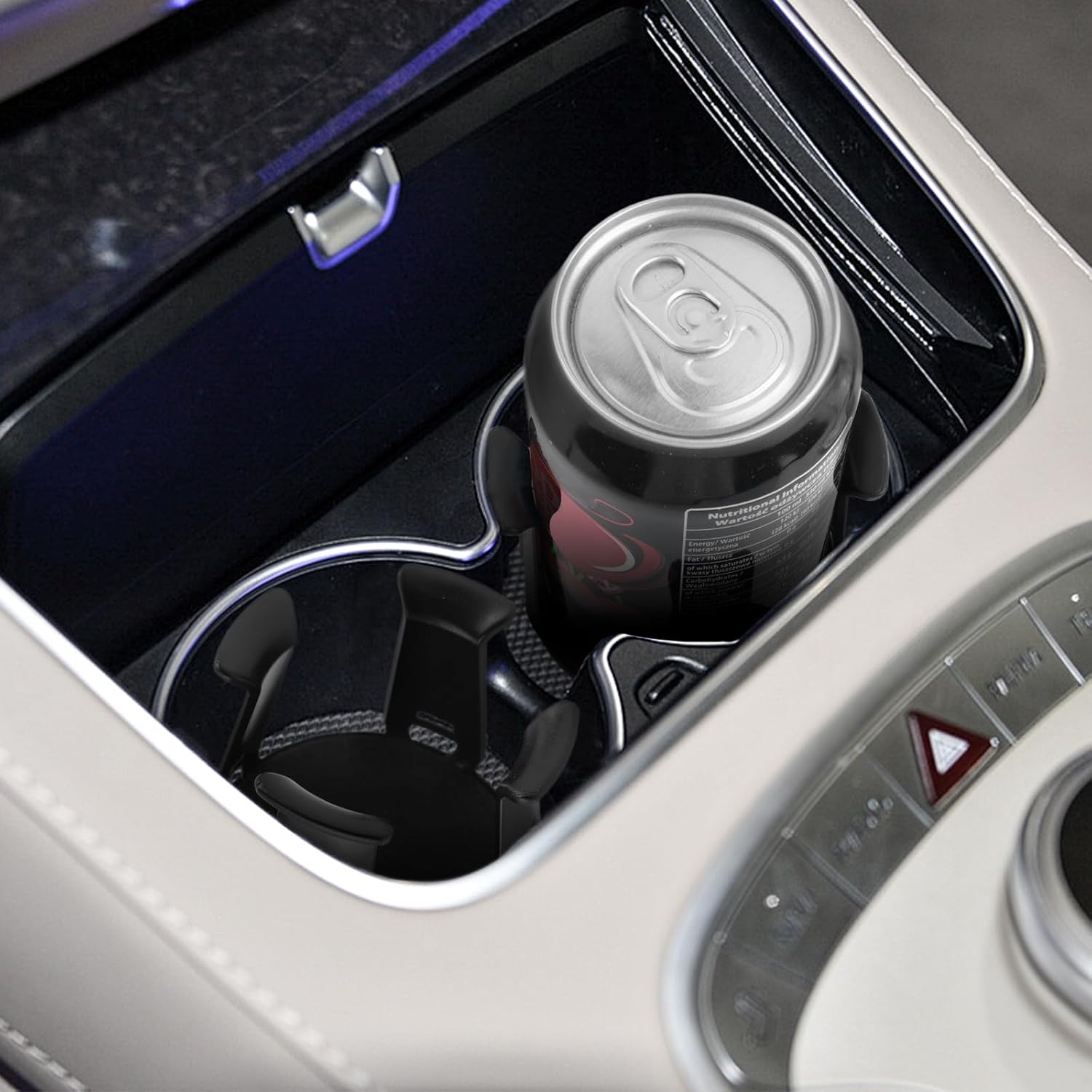Showcases the vehicle's cup holder design, emphasizing its ability to securely hold different sizes of beverage containers.