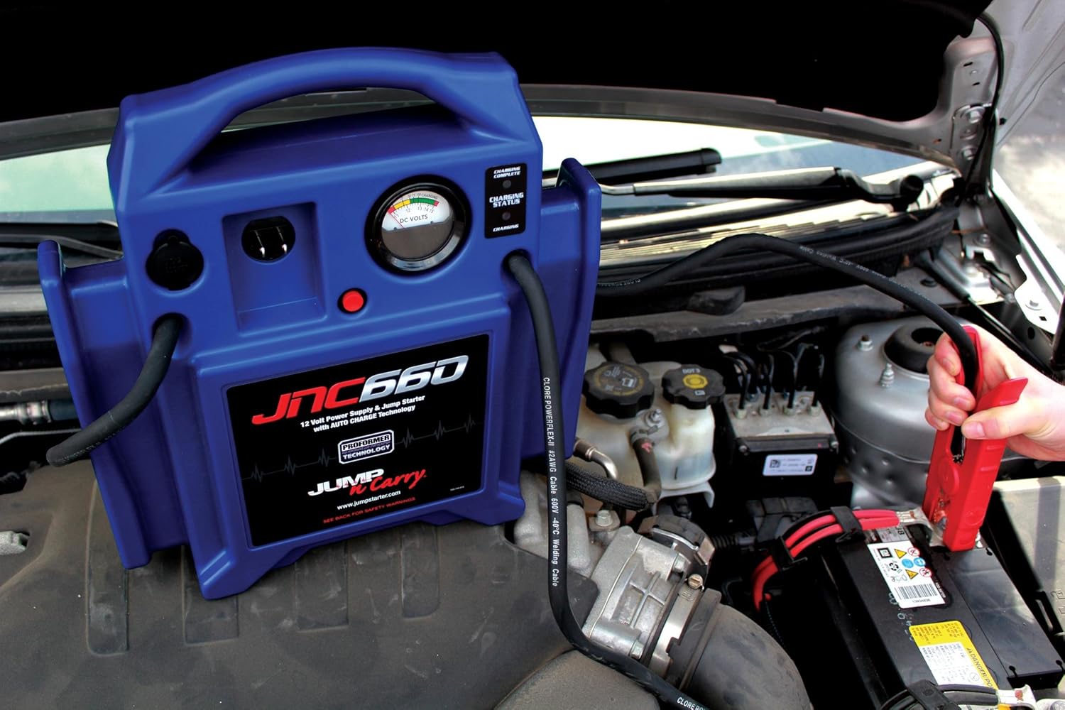 Demonstrates the product being used to jump start a car battery, showing its practical application in automotive emergencies.