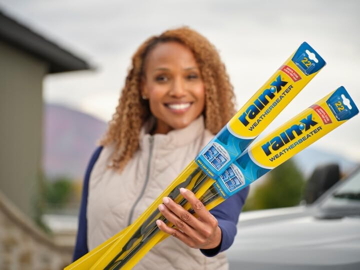 Shows a happy customer using the Rain-X Weatherbeater wiper blades in a real-world context, emphasizing the product's everyday usefulness and customer satisfaction.
