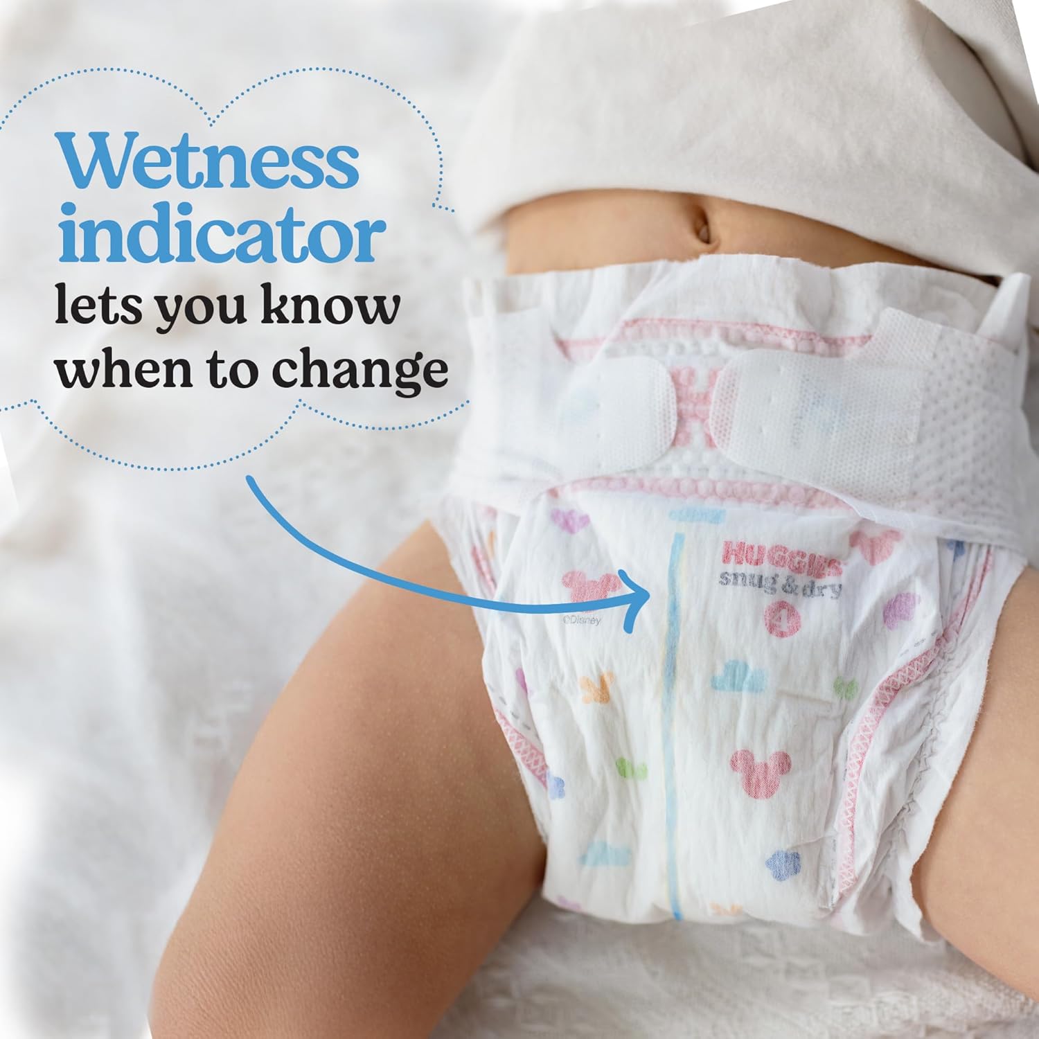 Highlights the diaper's wetness indicator feature to help parents know when it's time to change the baby's diaper.