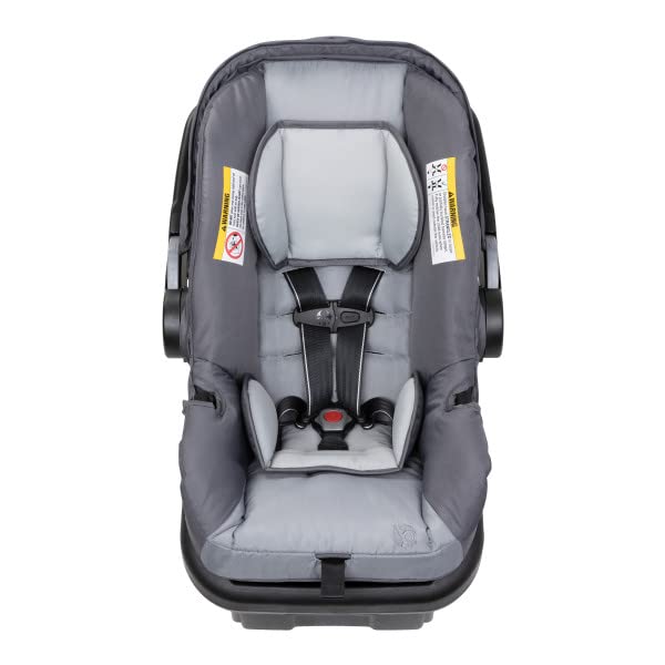 Demonstrates the safety features of the car seat, particularly the secure 5-point harness system, to reassure parents about their child's protection.