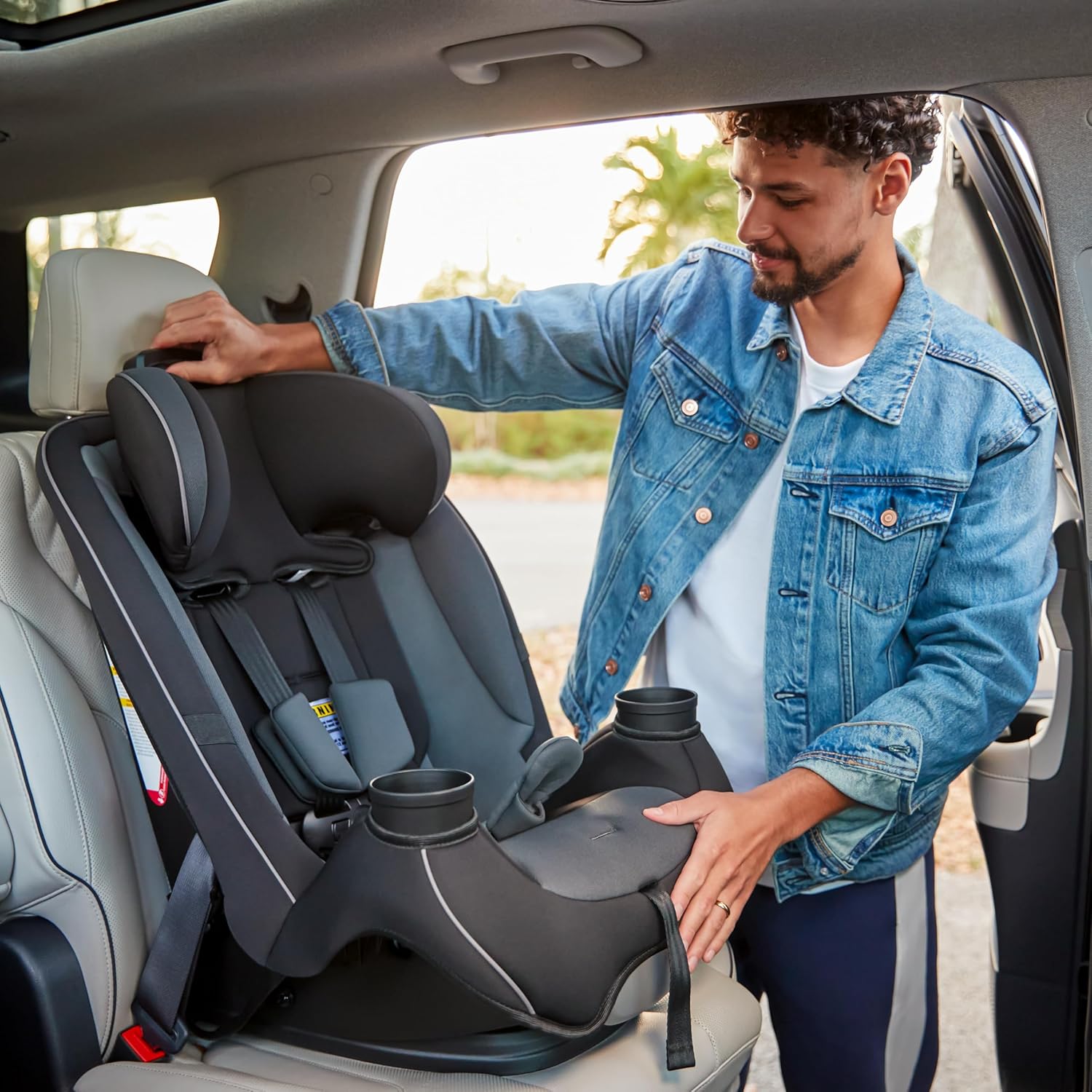 Highlights the convenience of integrated cup holders in the car seat, emphasizing a practical feature for parents on-the-go.