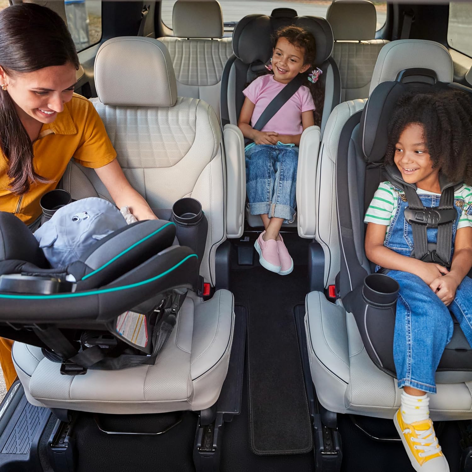 Demonstrates the vehicle's spacious interior and ability to accommodate multiple child car seats, appealing to families with young children.