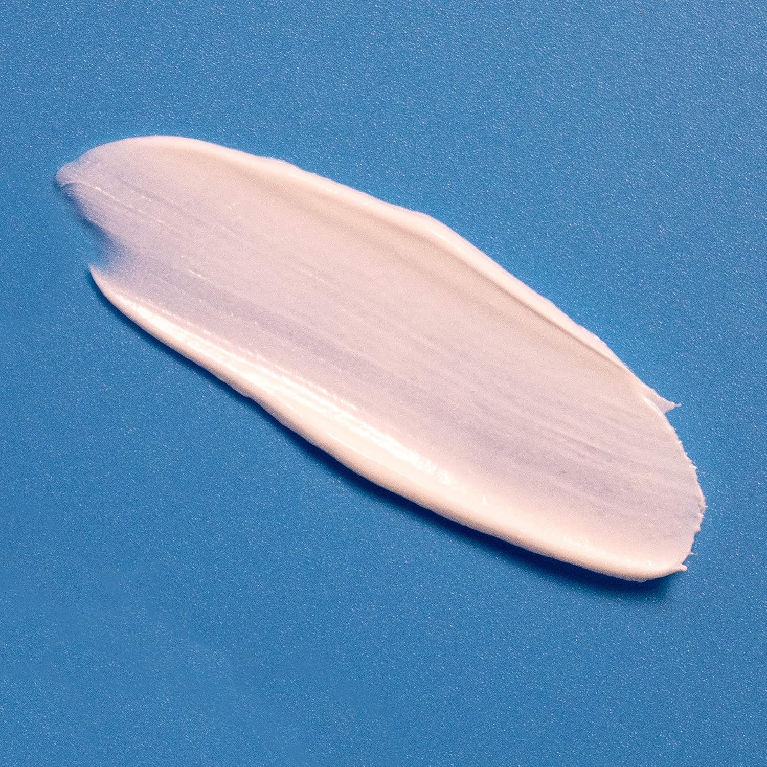 Demonstrates the product's creamy, smooth texture to highlight its easy application and blendability.