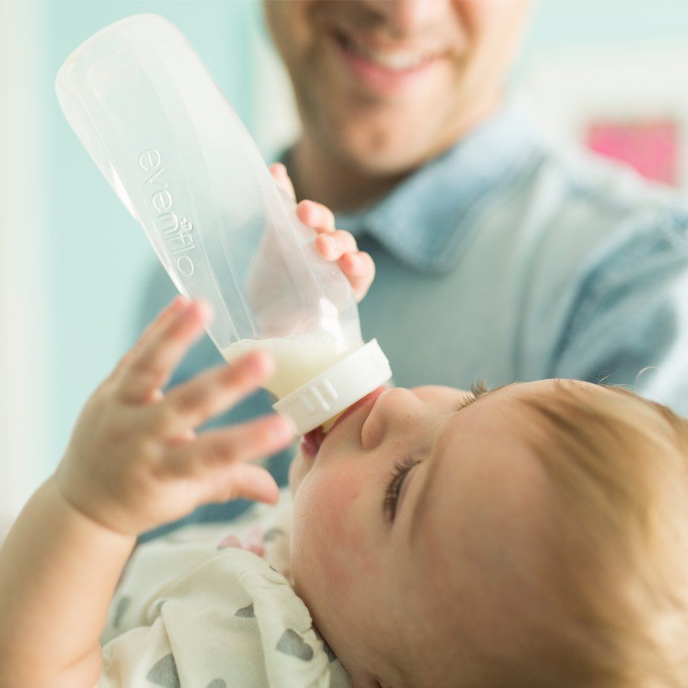 Shows the product being used in a real-life scenario, demonstrating how easy and natural it is to feed a baby with this bottle.