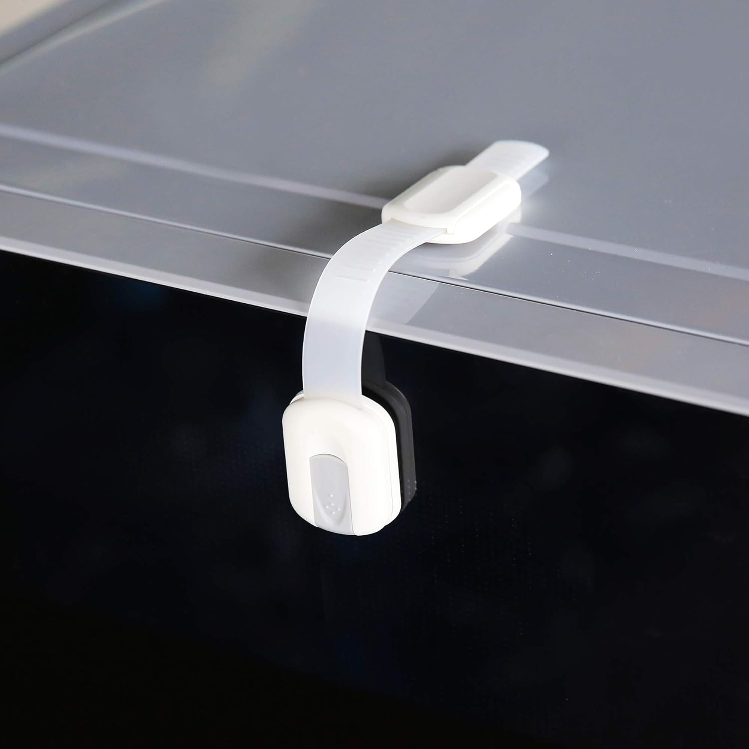Demonstrates the product's child safety feature, showing how it securely attaches to furniture to prevent children from accessing potentially dangerous areas.