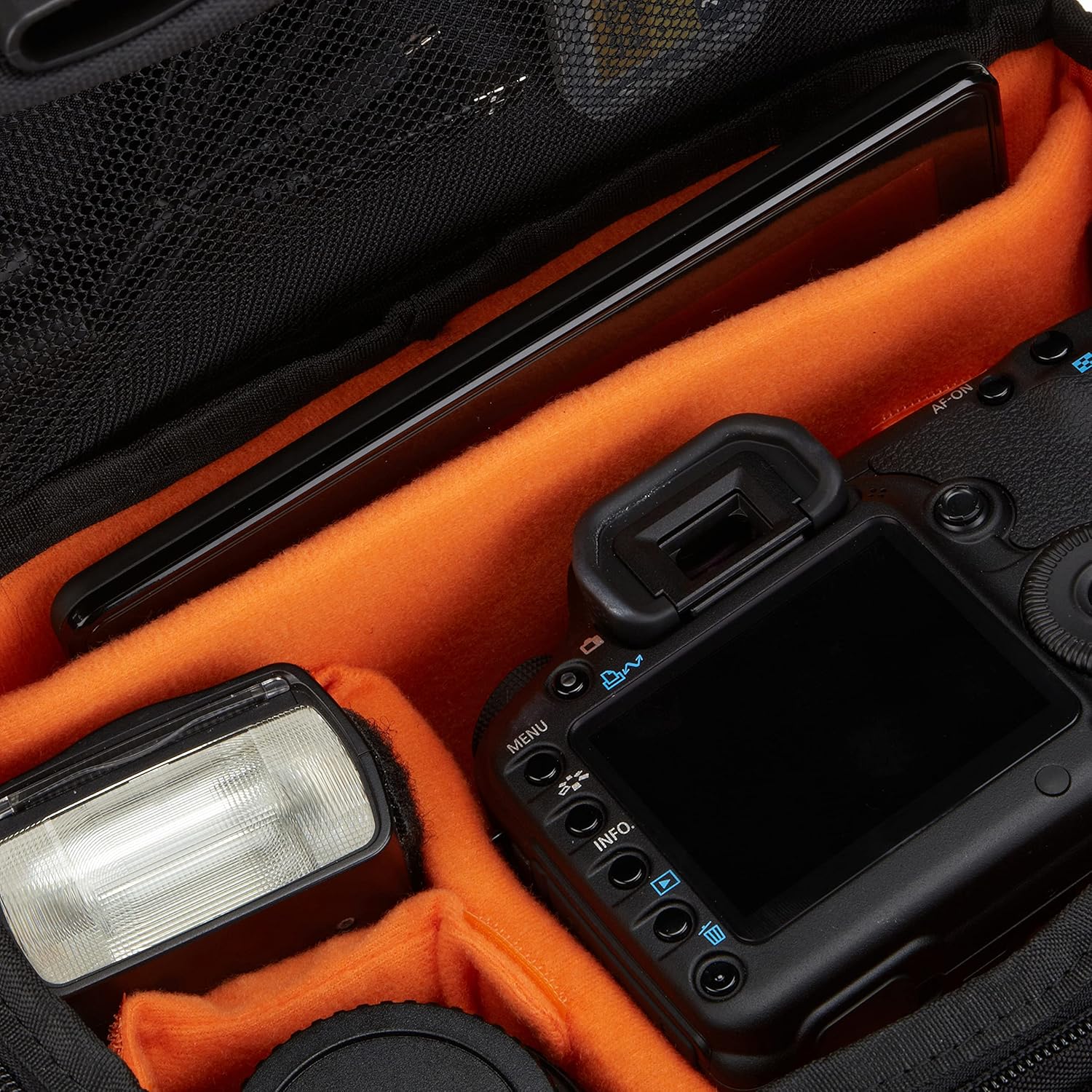 Shows the various camera equipment and accessories included in or compatible with the camera bag, demonstrating its capacity and organization features.