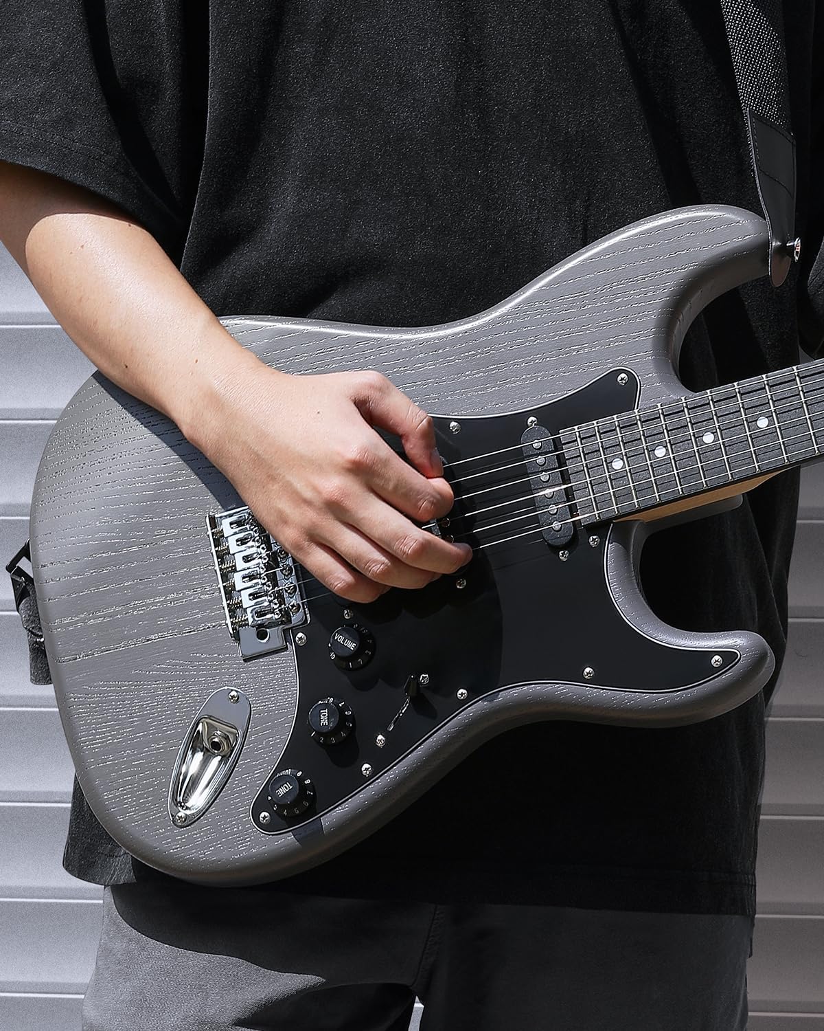 Shows the electric guitar being played, demonstrating its real-world application and appealing to musicians.