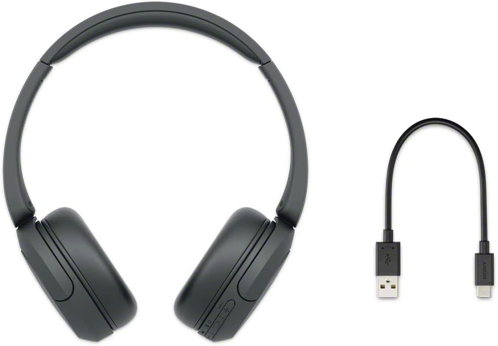 Shows the complete package contents, including the wireless headphones and the USB charging cable.