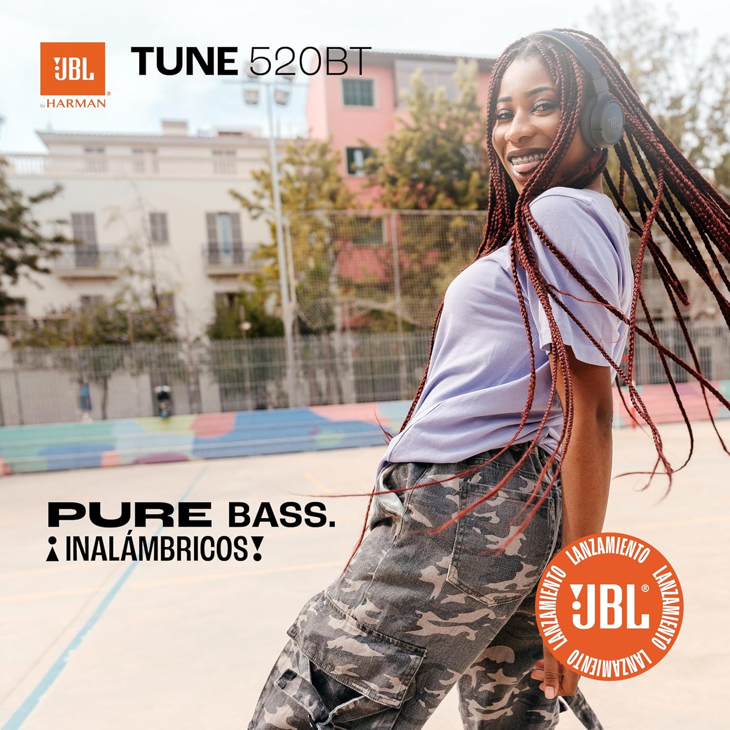 Shows the JBL Tune 520BT headphones being used in an urban outdoor setting, emphasizing their portability and suitability for active lifestyles. Highlights the 'Pure Bass' feature of the headphones,…