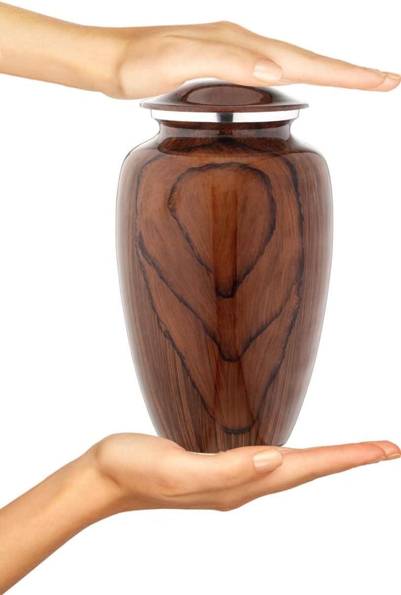 Demonstrates the small, manageable size of the urn by showing it held between two hands.