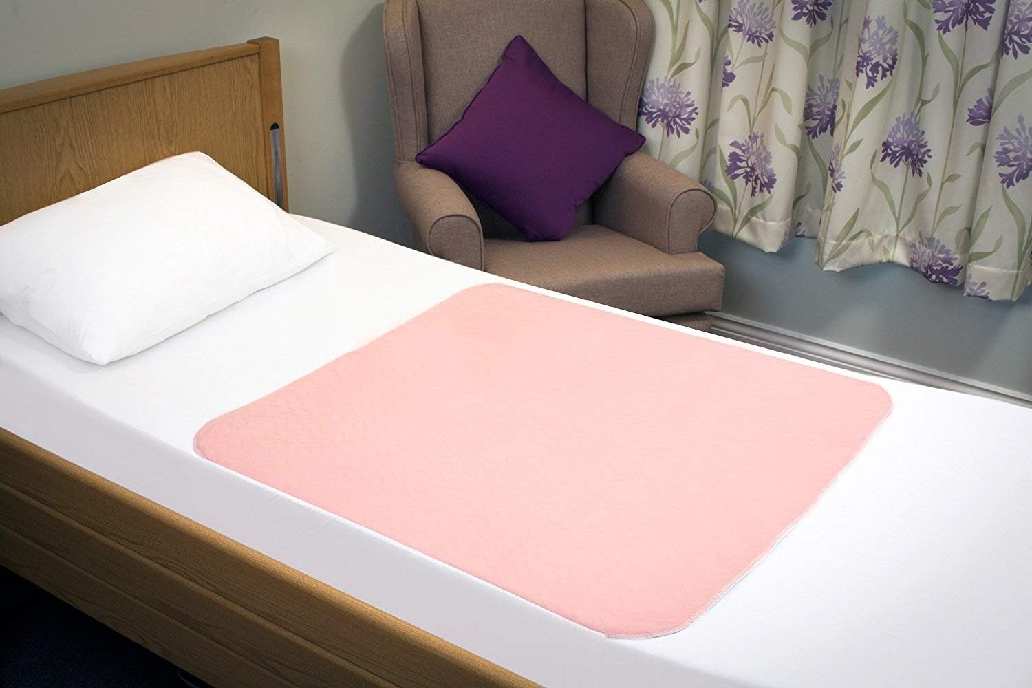 Shows the size and placement of a bed pad or protective sheet on a hospital-style bed, helping customers understand its coverage area.