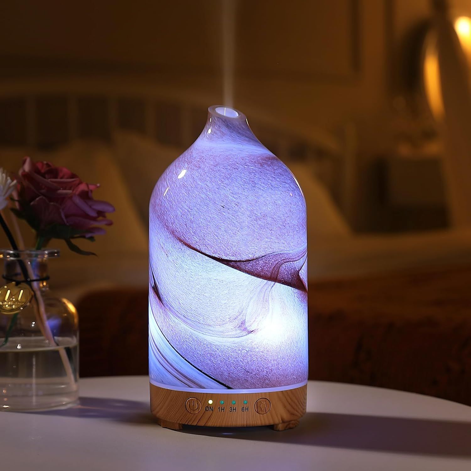 Shows the product in a real-world home setting to help shoppers visualize how the diffuser looks when lit and placed in their own living space.