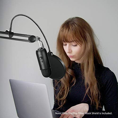 Demonstrates the product in a real-world use case showing a person using the microphone with a pop filter for content creation or recording.