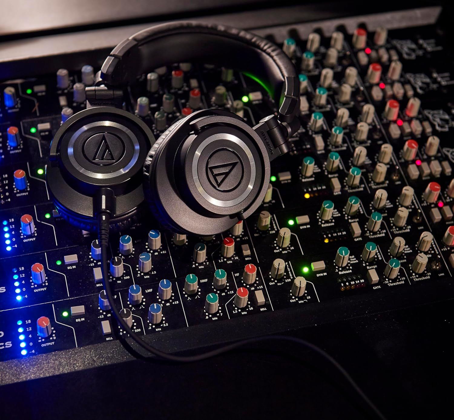 Shows the headphones in a real-world professional audio mixing context to help shoppers visualize the product being used with studio equipment and understand its intended application.