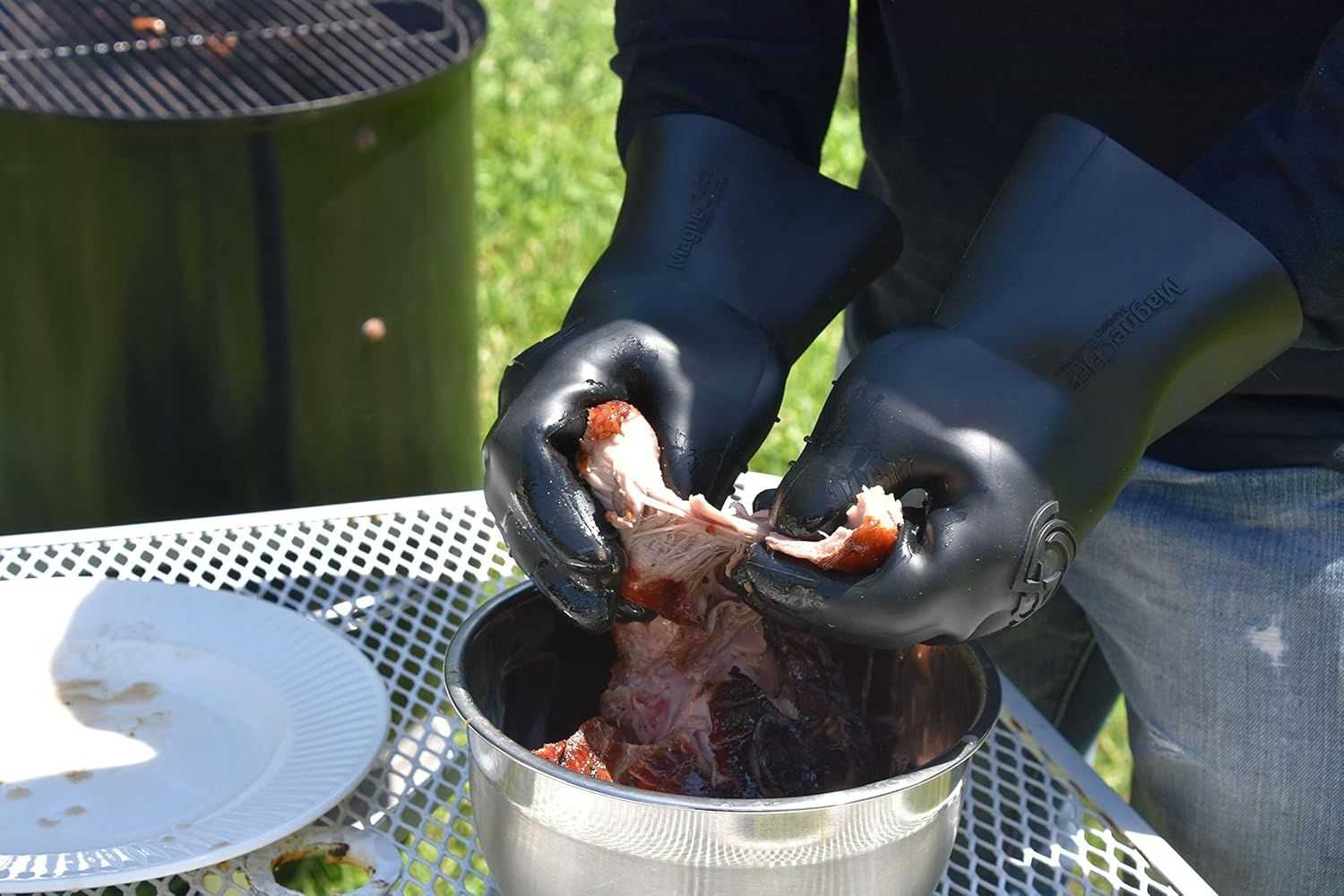 Demonstrates the product's effectiveness for handling hot food during outdoor grilling and BBQ activities, showing its practical application in a real-world cooking scenario.
